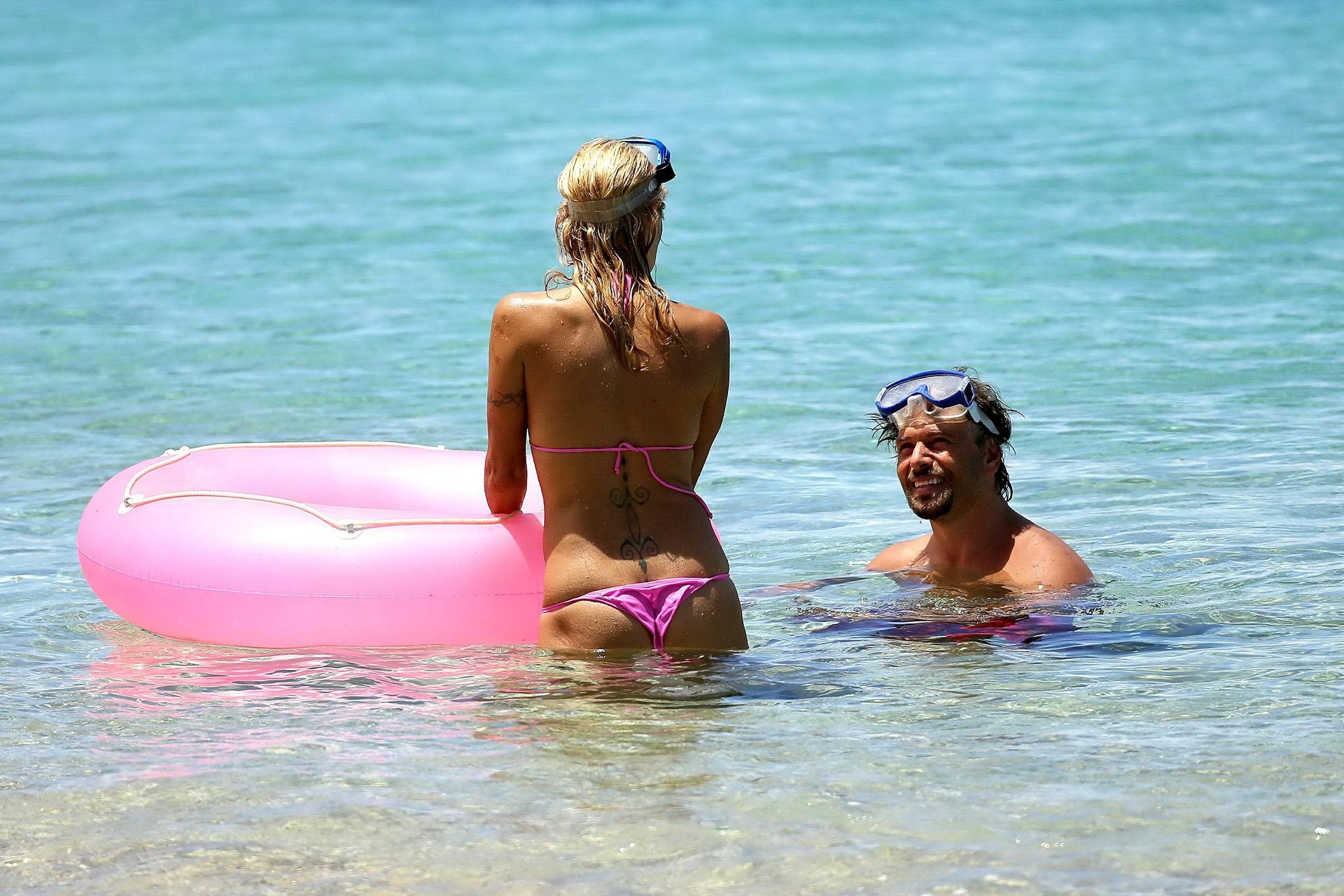 Busty pamela anderson mostrando pokies in un bikini rosa bagnato mentre lo snorkeling su un 
 #75221506