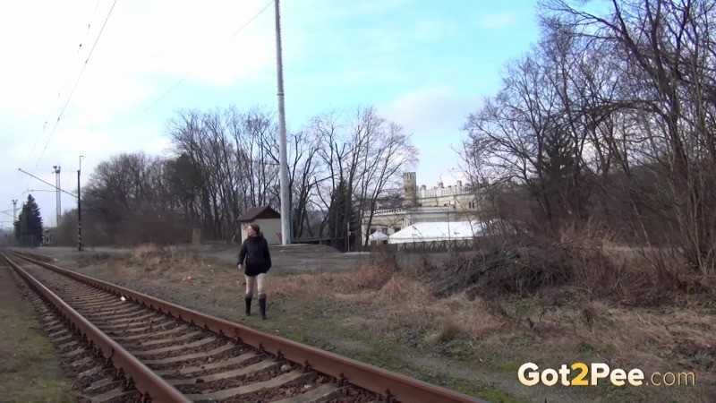 Brunette girl pulls down her trousers to pee outside #67493276