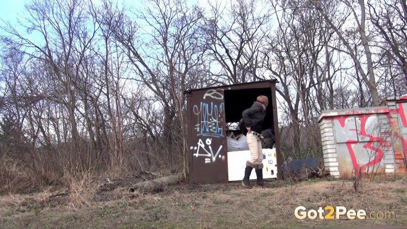 Brunette girl pulls down her trousers to pee outside #67493285