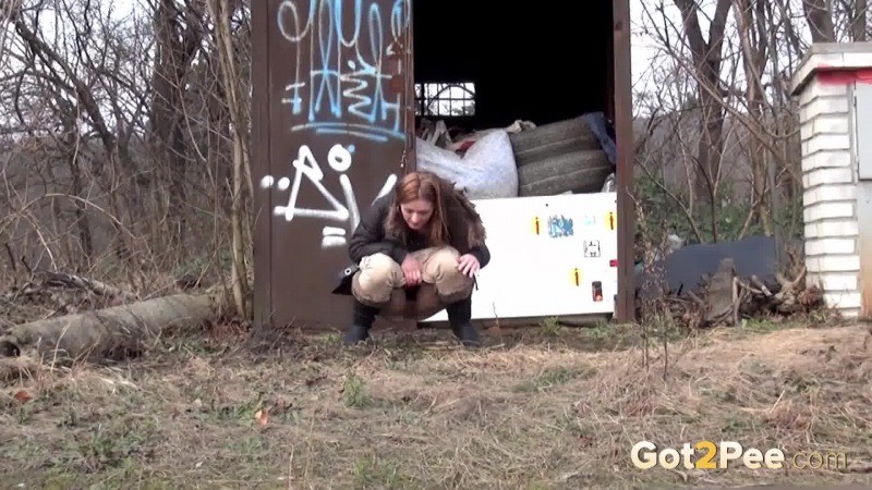 Brunette girl pulls down her trousers to pee outside #67493321