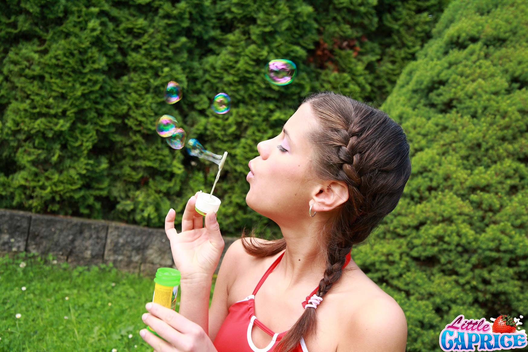 Teen schoolgirl blowing bubbles outside #74812194