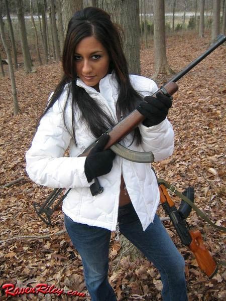 Babe posing with a gun in the woods #75101380