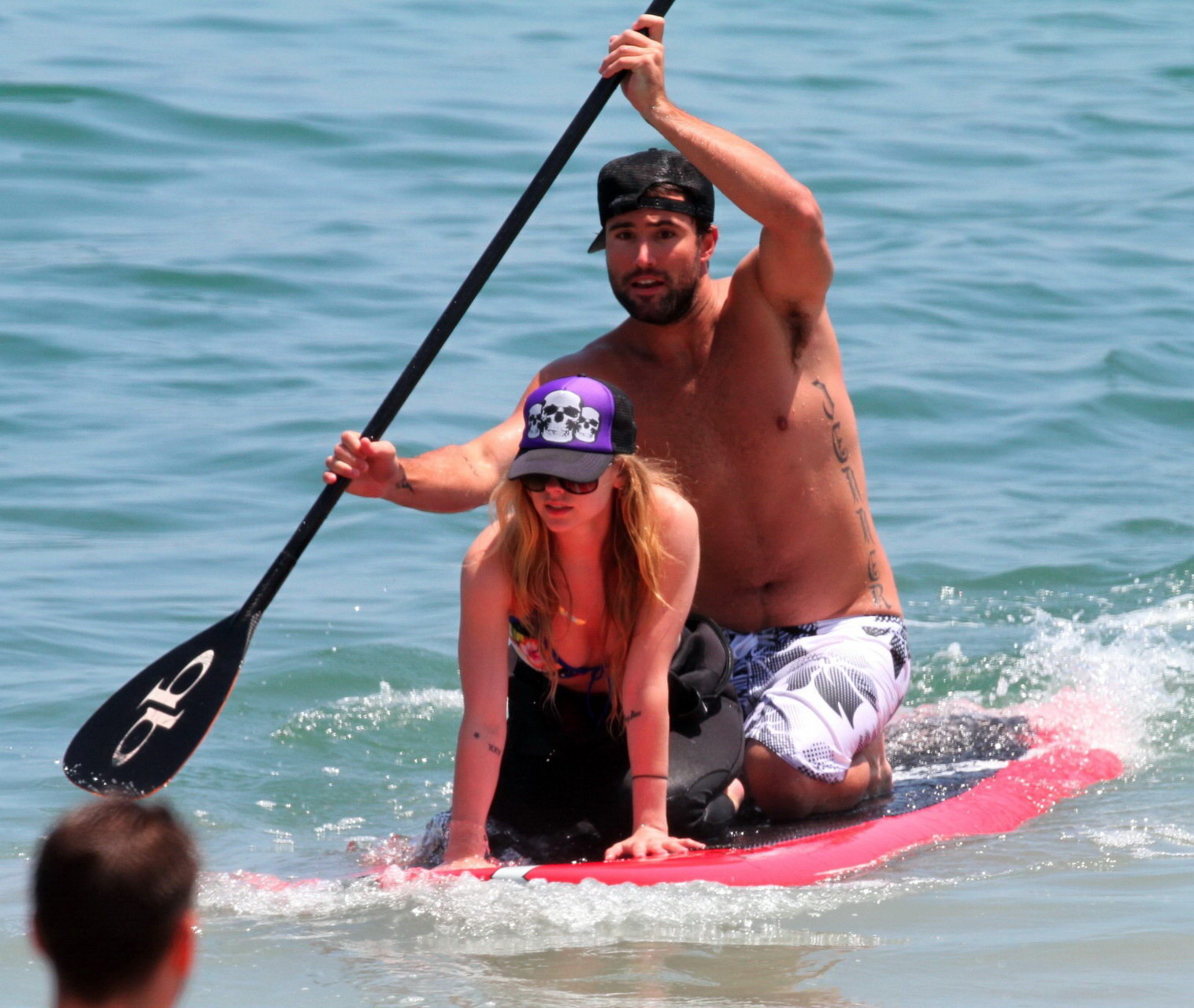 Avril Lavigne wearing a bikini top and a wetsuit on the beach in Malibu #75342718