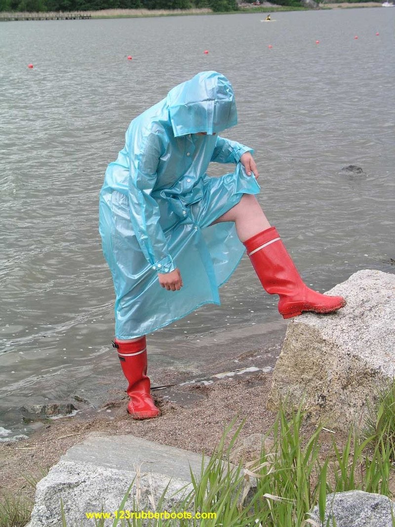 Cute redhead in sexy rubber boots and raincoat #76647901