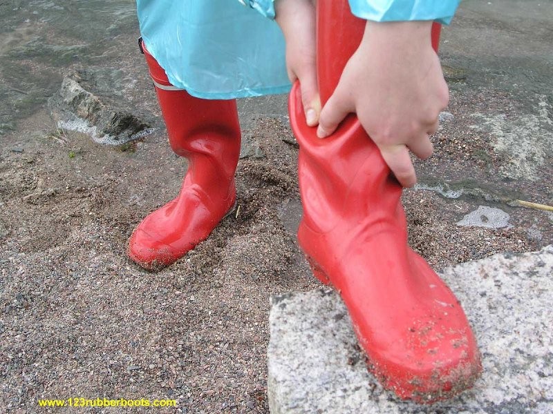 Cute redhead in sexy rubber boots and raincoat #76647906