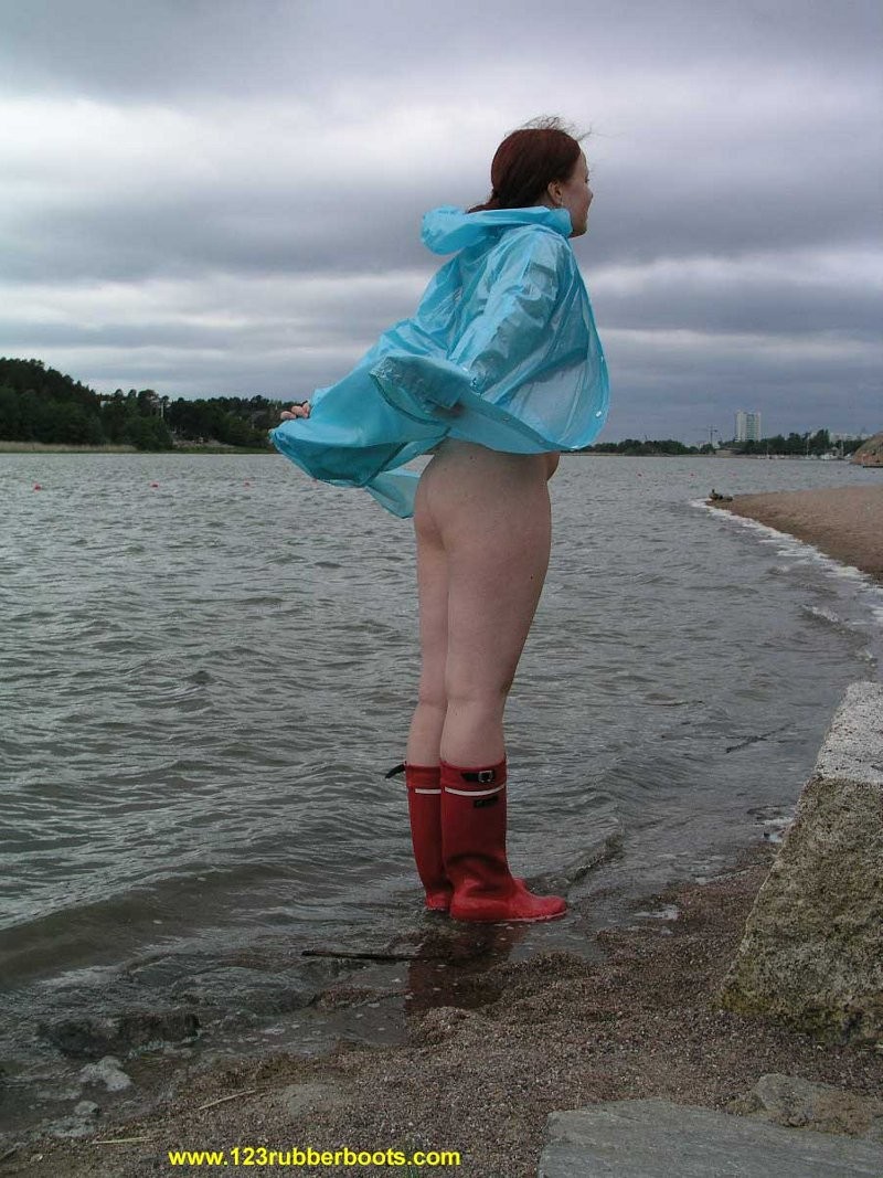 Cute redhead in sexy rubber boots and raincoat #76647925