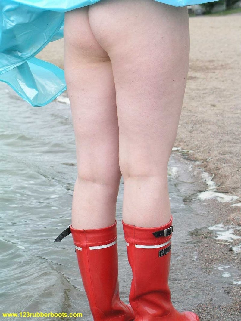 Cute redhead in sexy rubber boots and raincoat #76647930