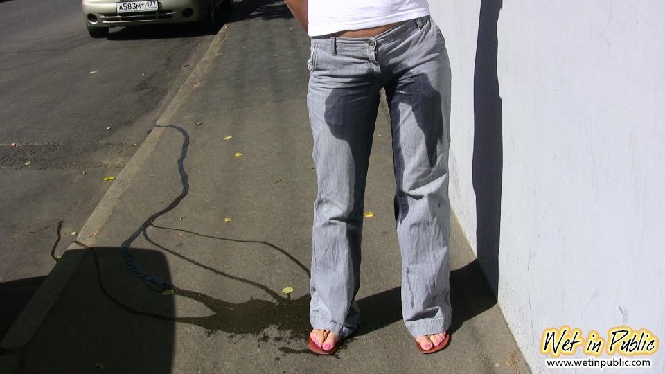 Wet outdoor gray jeans of a bunny who needed to do a pee and did it #73245397