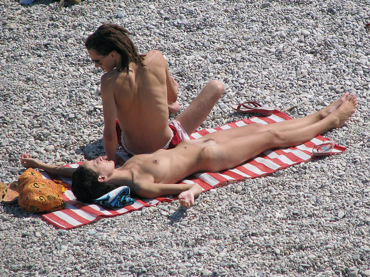 Brunette hottie lays around nude at the beach #72235975