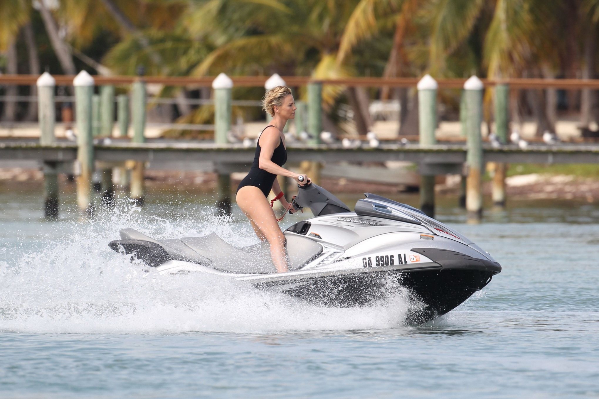 Charlize Theron jet skiing in black monokini during the photoshoot in Miami Beac #75201303