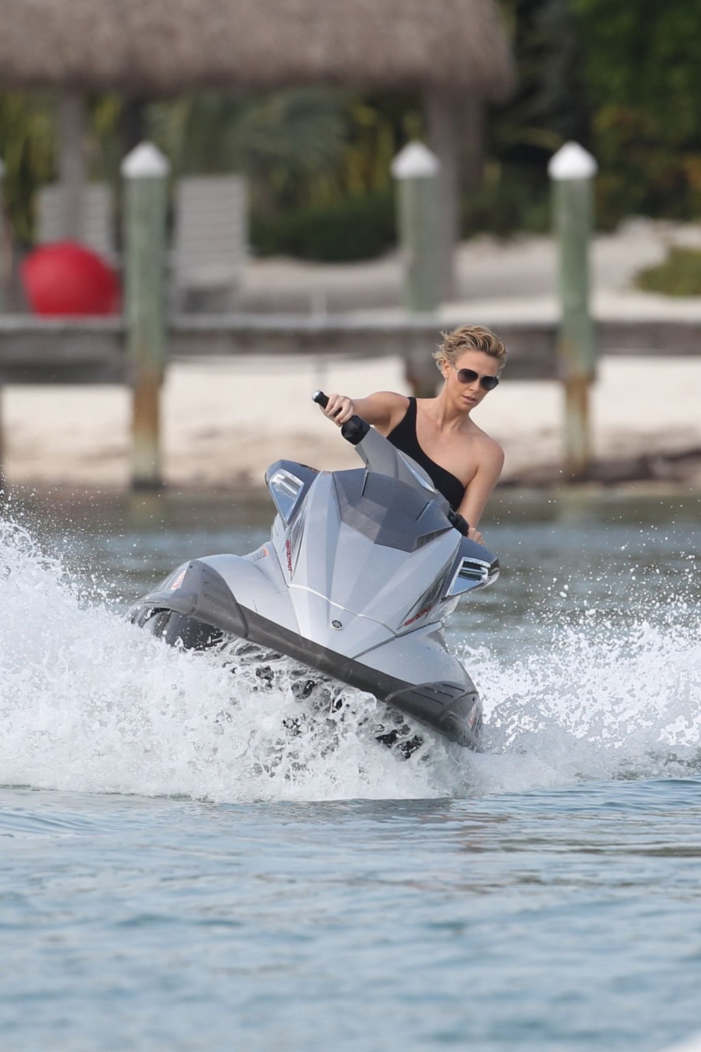 Charlize Theron jet skiing in black monokini during the photoshoot in Miami Beac #75201317