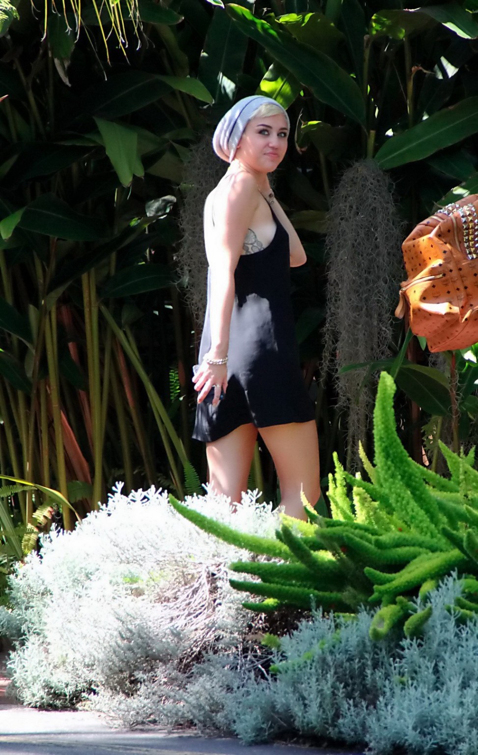 Miley Cyrus braless wearing black backless mini dress at a Recording Studio in H #75236423