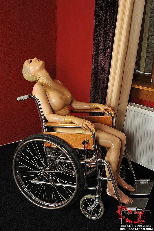 Lucy, une poupée en latex, est attachée à un fauteuil roulant et manipulée.
 #71982053