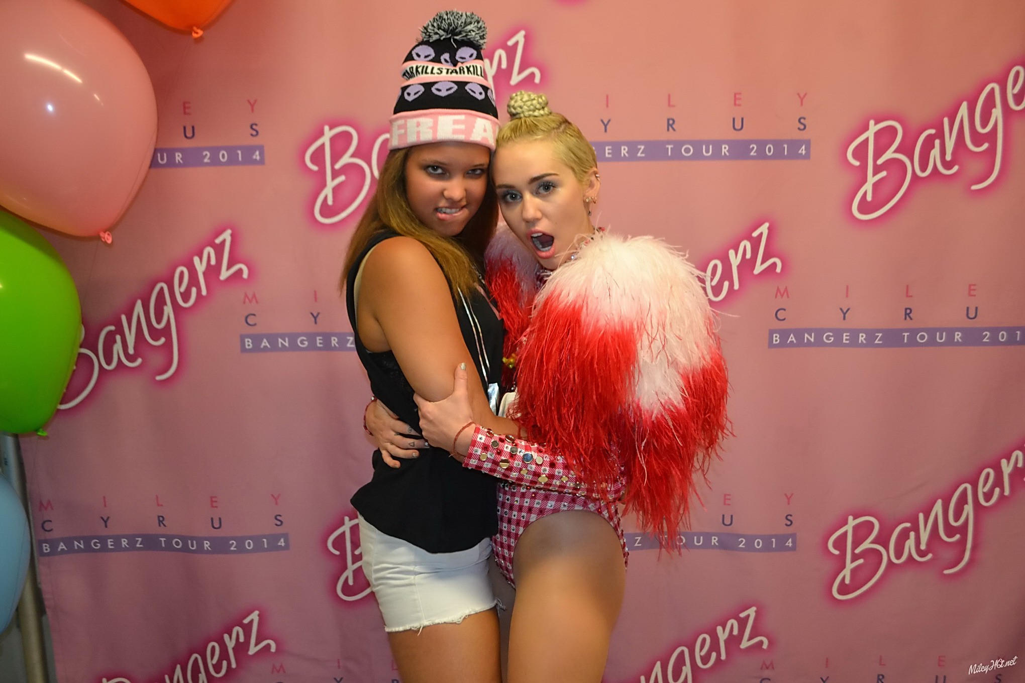 Miley Cyrus licking a fan while posing for Meet and Greet event at United Center #75188088