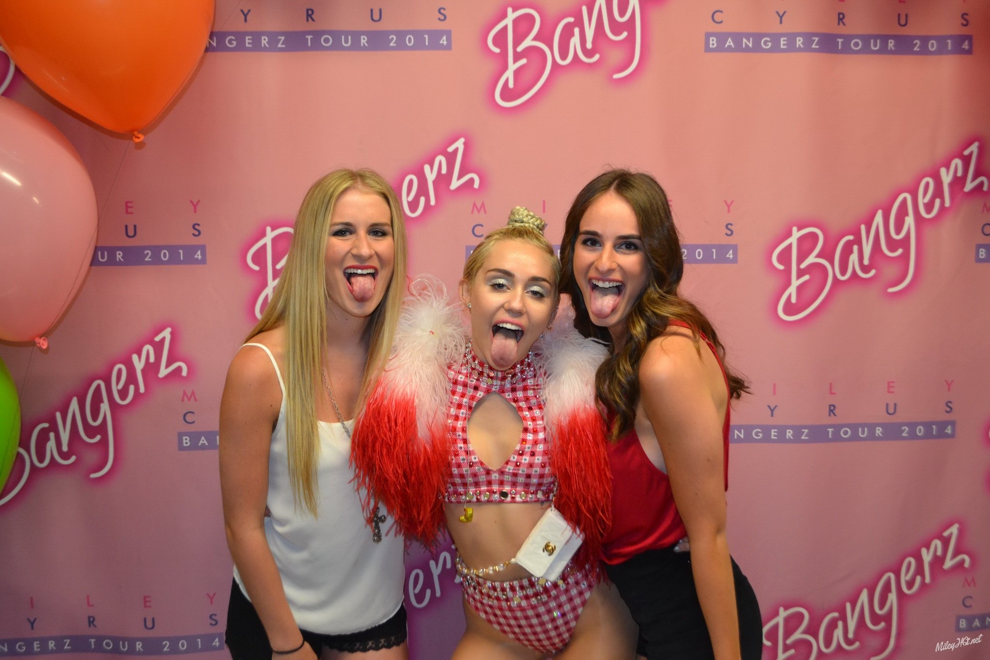 Miley Cyrus licking a fan while posing for Meet and Greet event at United Center #75188162