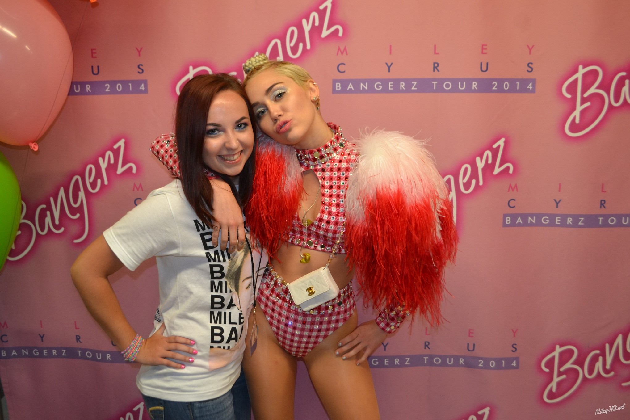 Miley Cyrus licking a fan while posing for Meet and Greet event at United Center #75188168