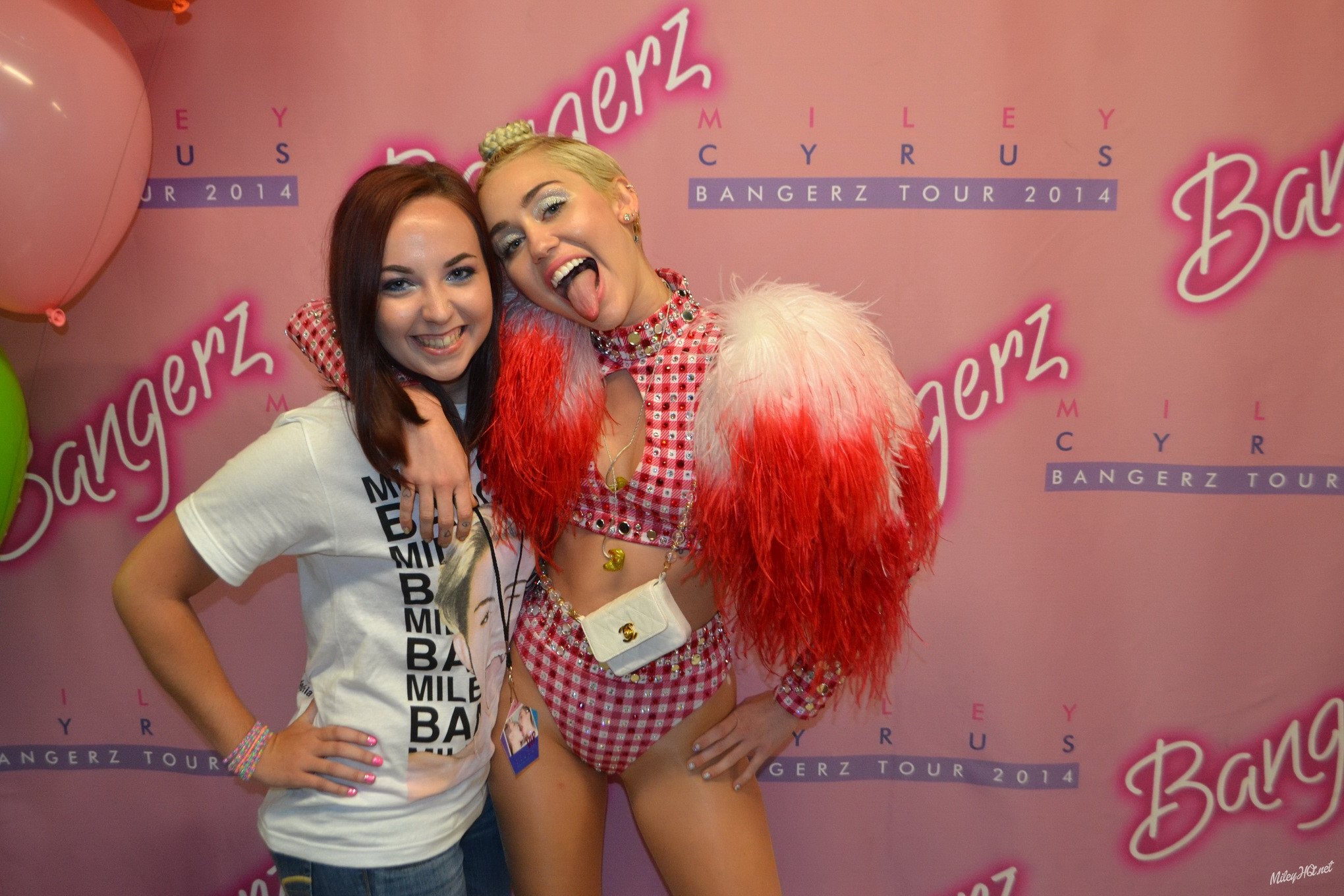 Miley Cyrus licking a fan while posing for Meet and Greet event at United Center #75188177