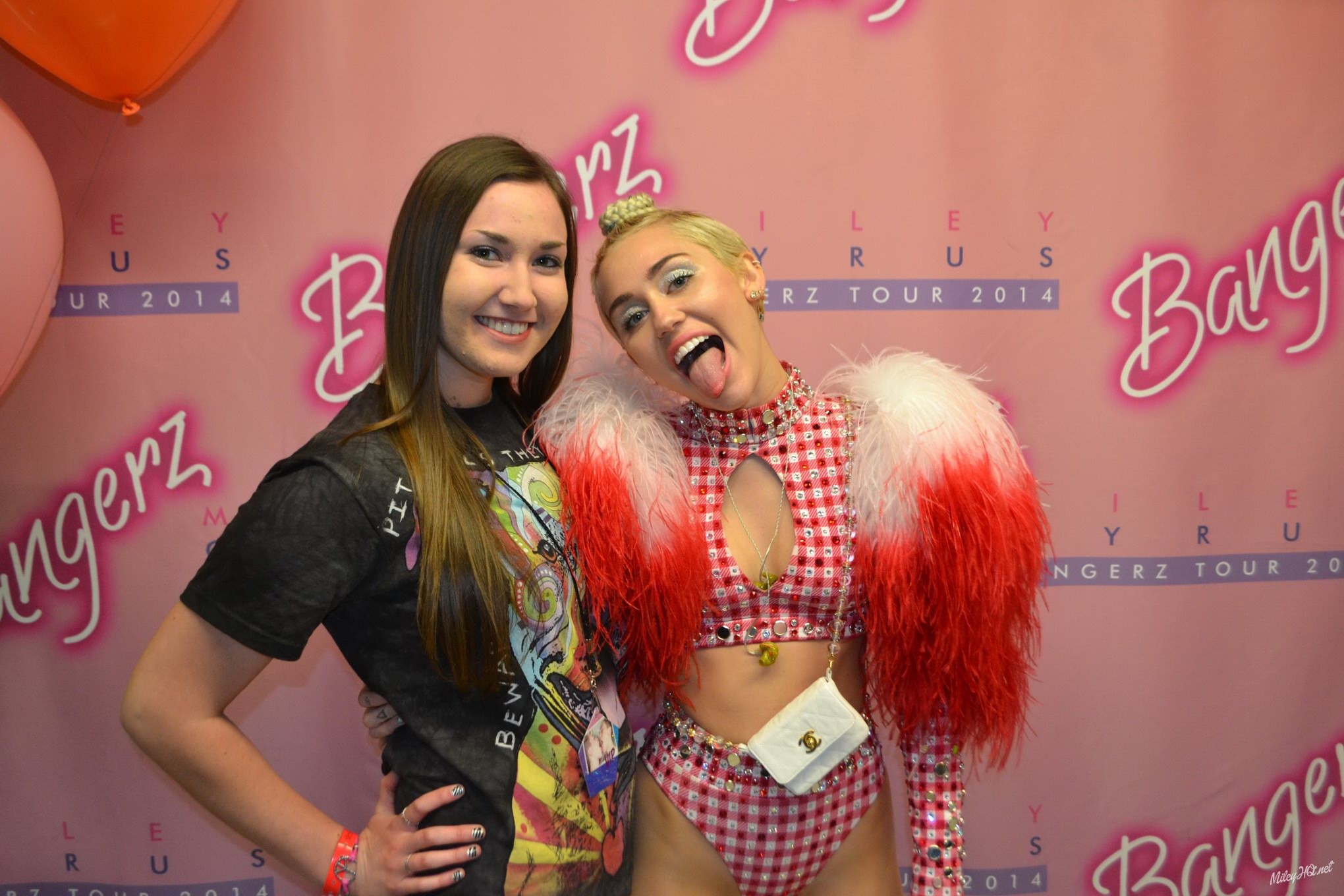 Miley Cyrus licking a fan while posing for Meet and Greet event at United Center #75188184