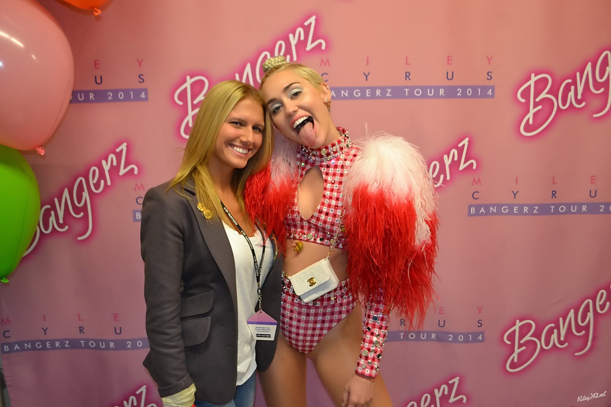 Miley Cyrus licking a fan while posing for Meet and Greet event at United Center #75188188