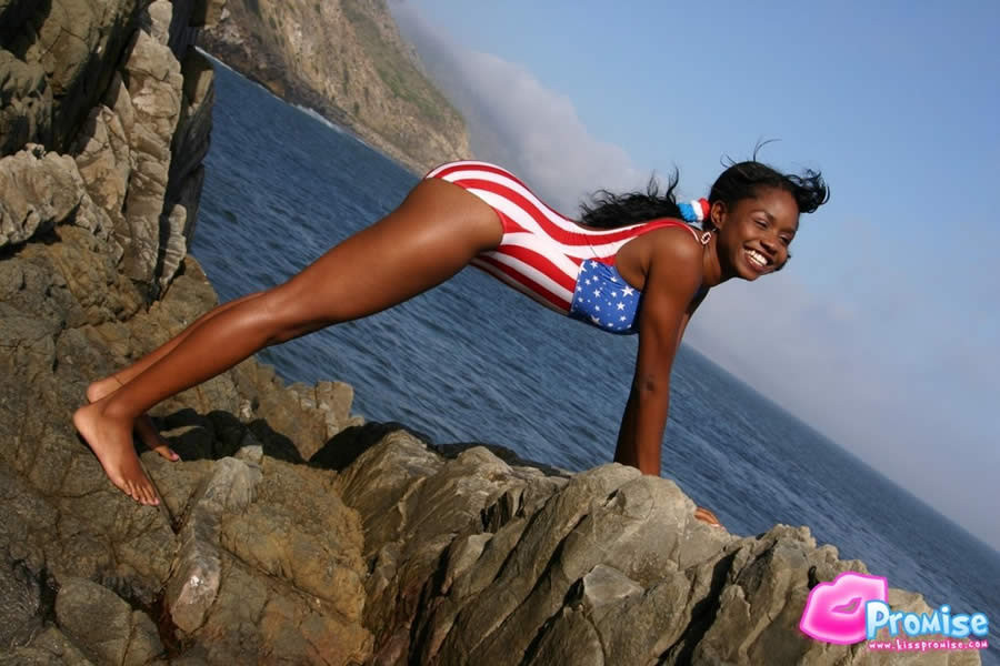 Ebony teen in bathing suit strips by the ocean #73422293