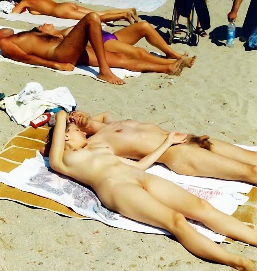 Naked teens play together at a public beach #70068465