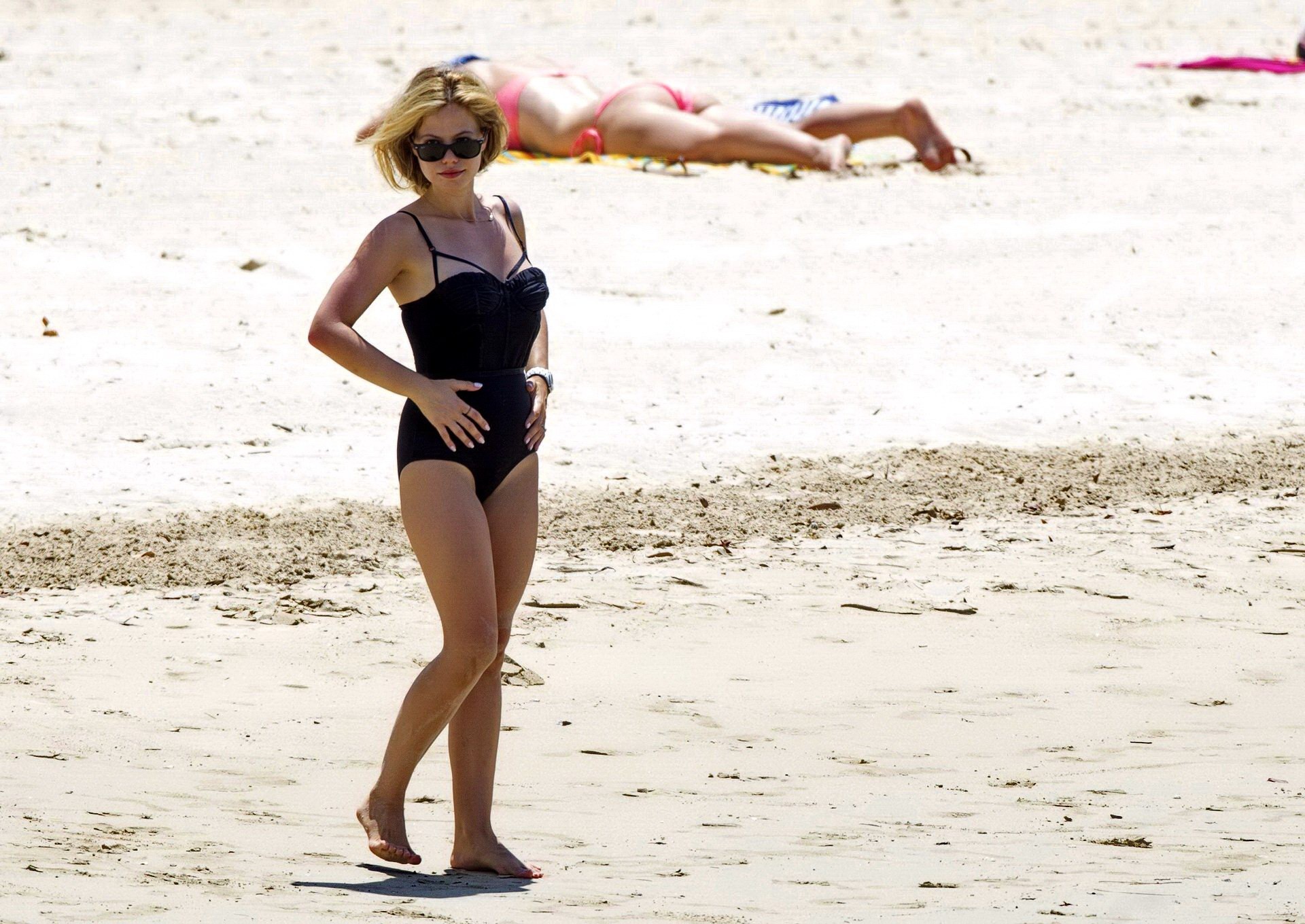 Tammin Sursok wearing a black swimsuit on a beach in Sydney #75178023