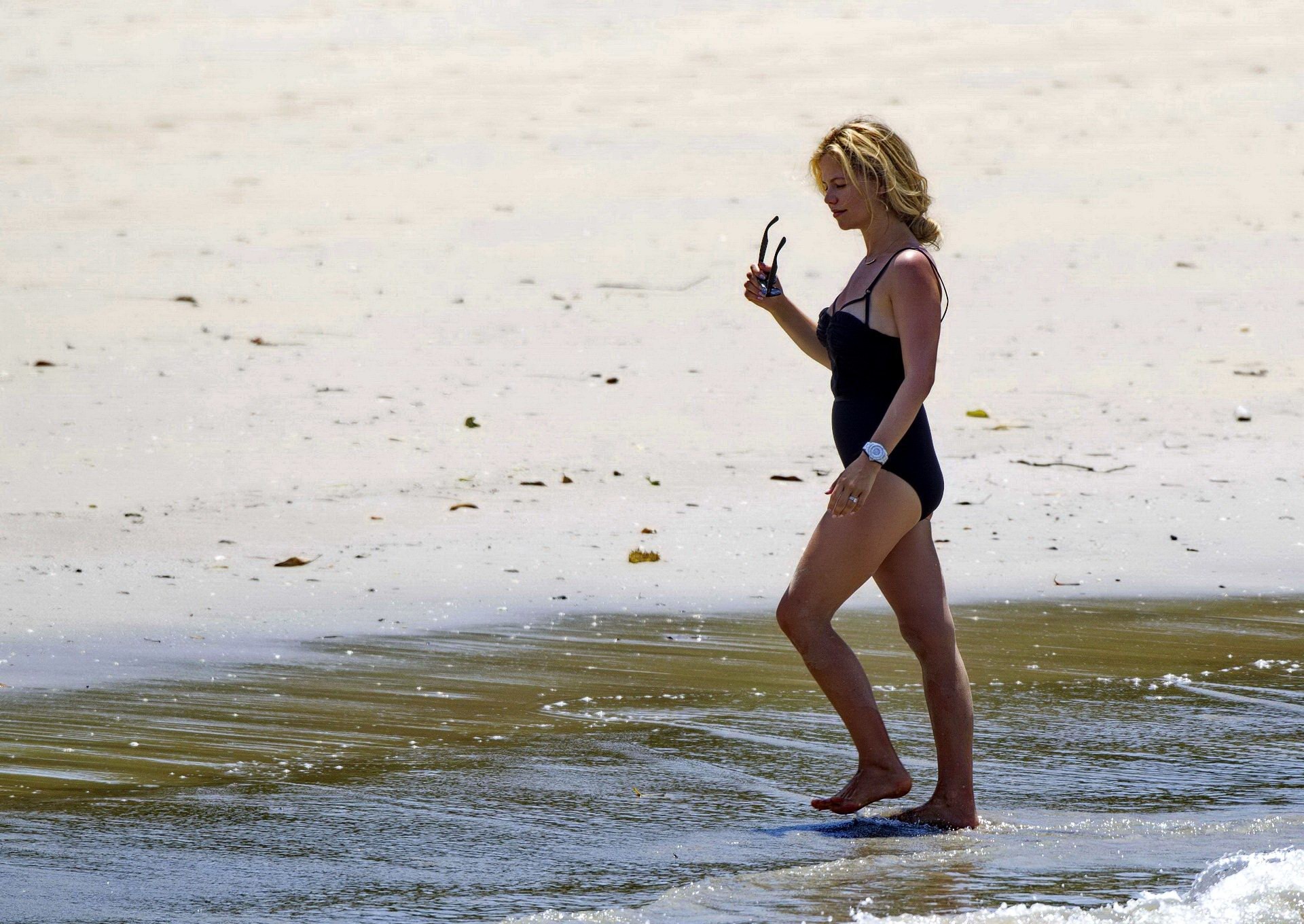 Tammin Sursok wearing a black swimsuit on a beach in Sydney #75178043