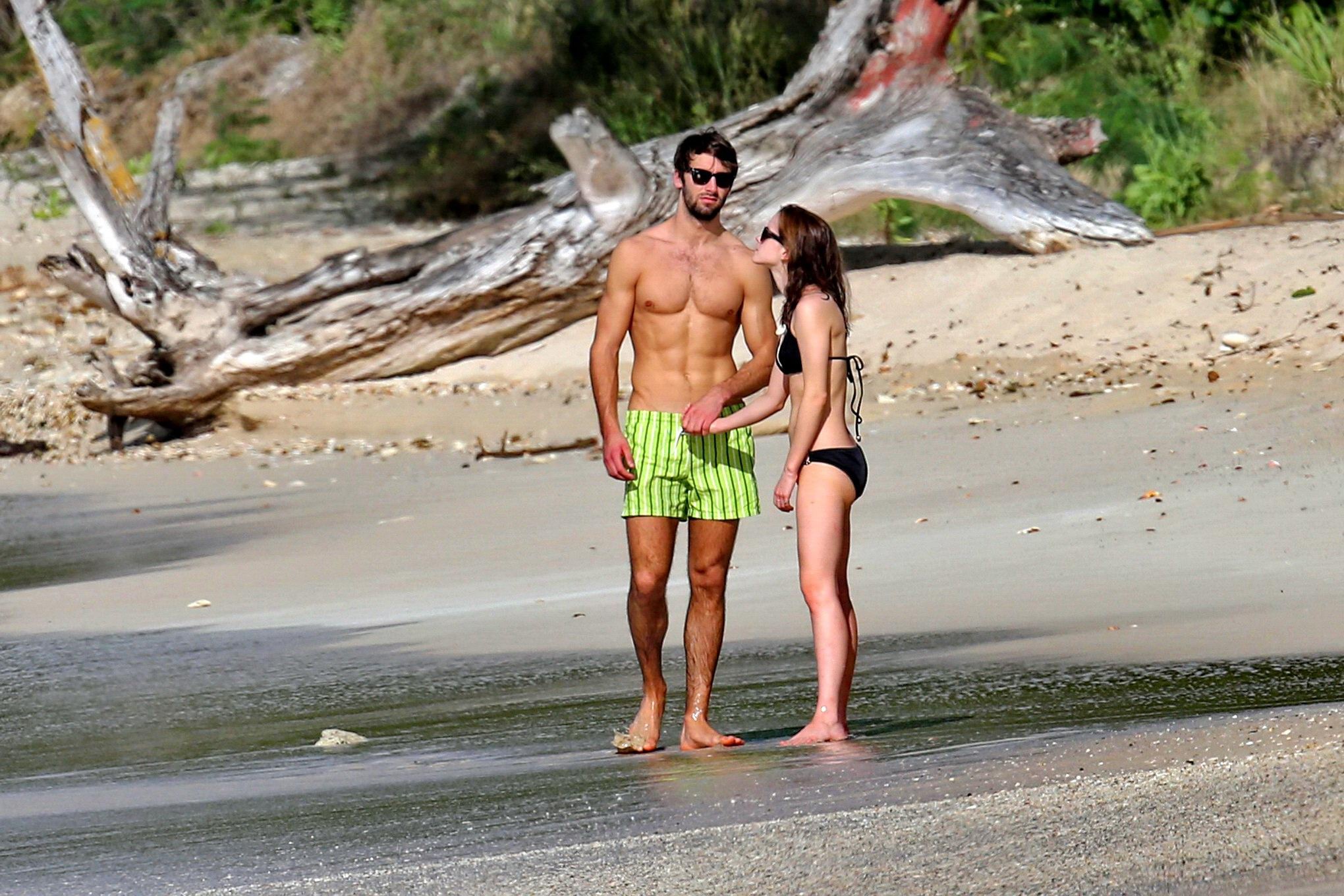 Emma Watson in black bikini petting with her boyfriend on a Carribean beach #75207871