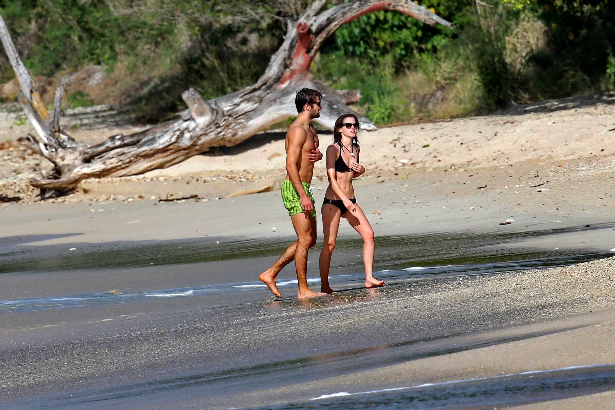 Emma Watson in black bikini petting with her boyfriend on a Carribean beach #75207887