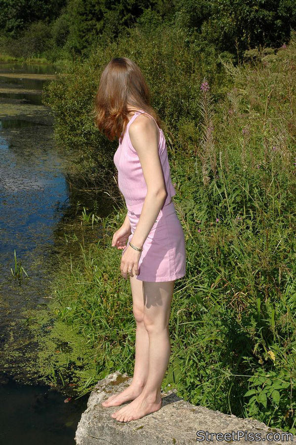Leggy young hottie parades pee play on a bank #76562649