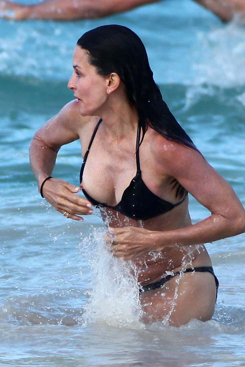 Courteney Cox nipple slip and looking very sexy in black bikini on beach paparaz #75309837