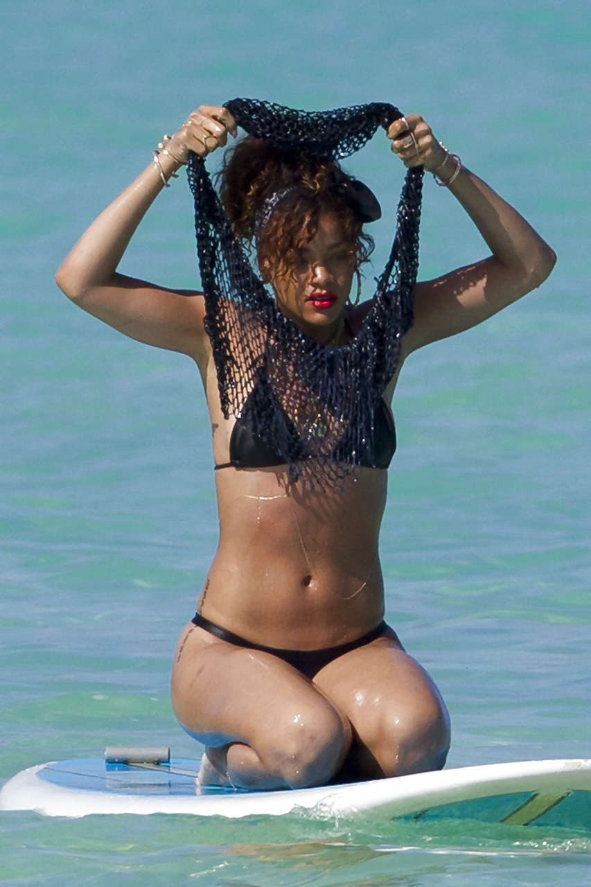 Rihanna showing her great ass in black thong on beach paparazzi photos #75275629