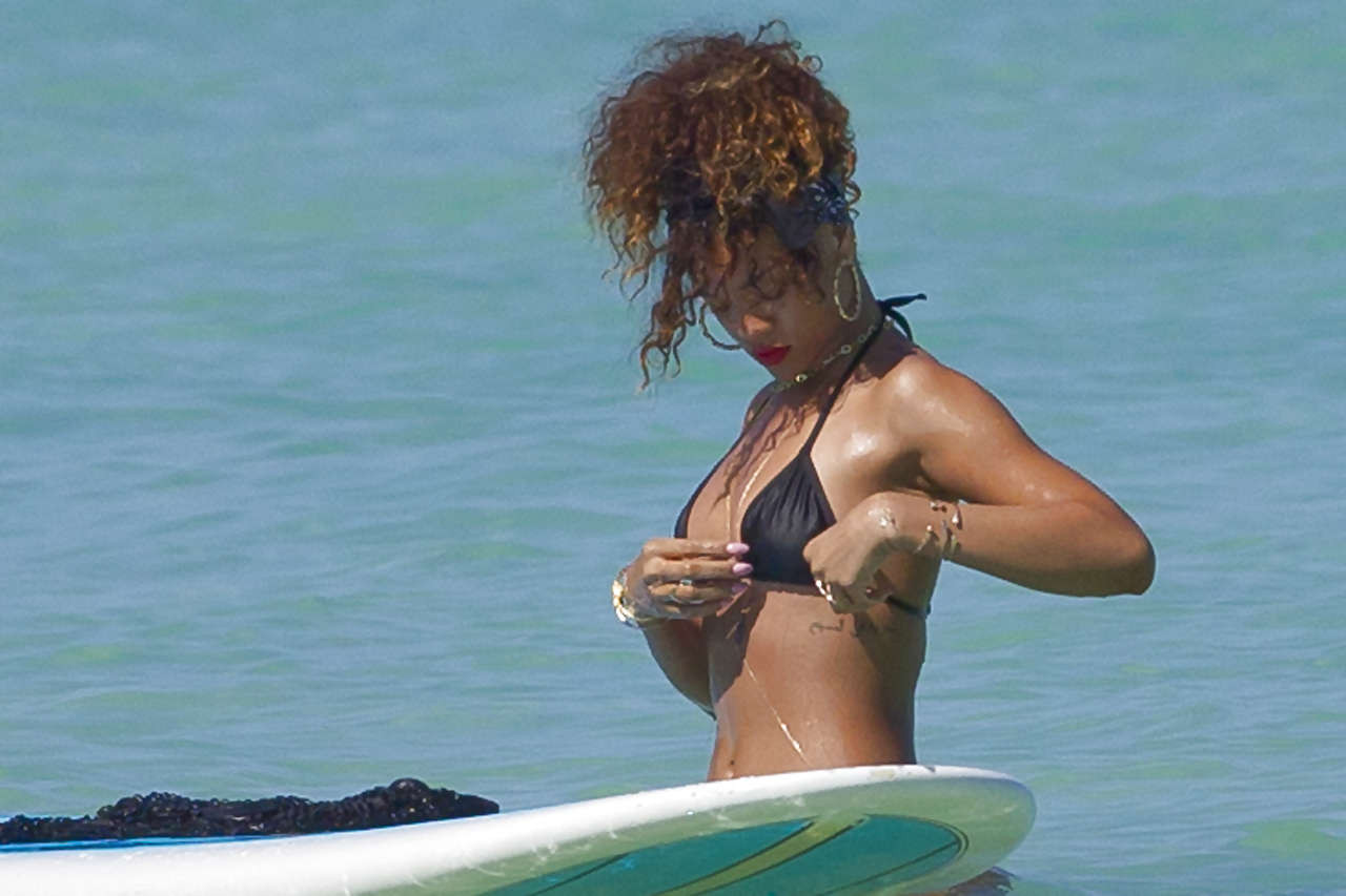 Rihanna showing her great ass in black thong on beach paparazzi photos #75275657