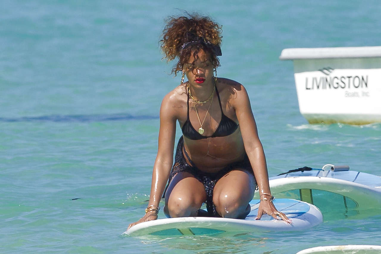 Rihanna showing her great ass in black thong on beach paparazzi photos #75275673