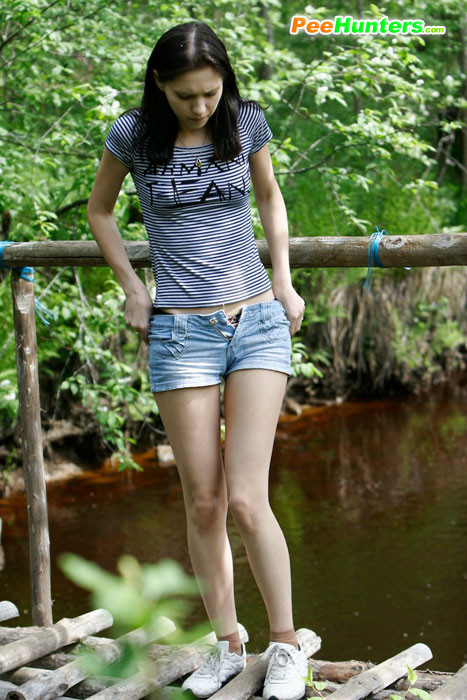 Leggy tart peeing from run-down bridge in country #78690801