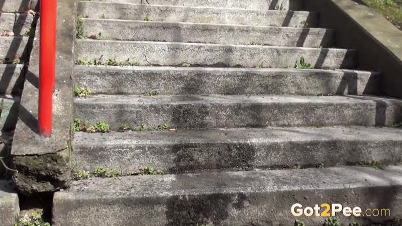 Dark haired girl pisses on concrete steps #67499803