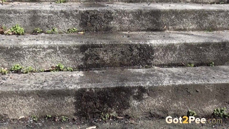 Dark haired girl pisses on concrete steps #67499813