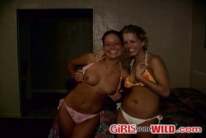 Two tan bikini babes flashing their perky young tits #73207222