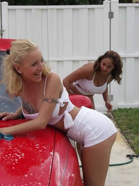 Two amateur girls playing and washing a car #74098094