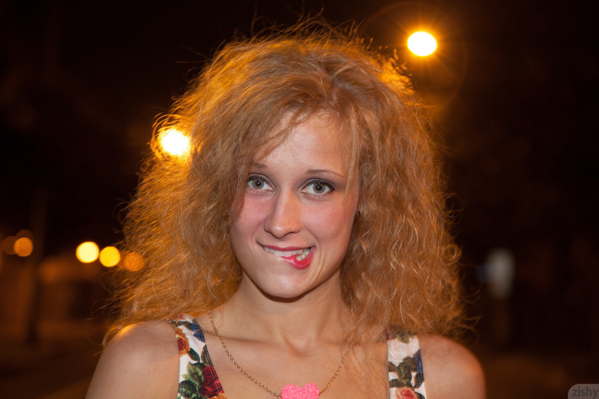 Rebel girl with curly hair smoking under a no smoking sign #67337379