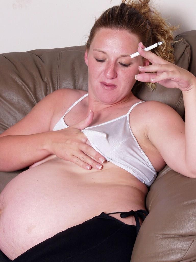 Smoking pregnant babe teasing and spreading her shaved twat #76640487