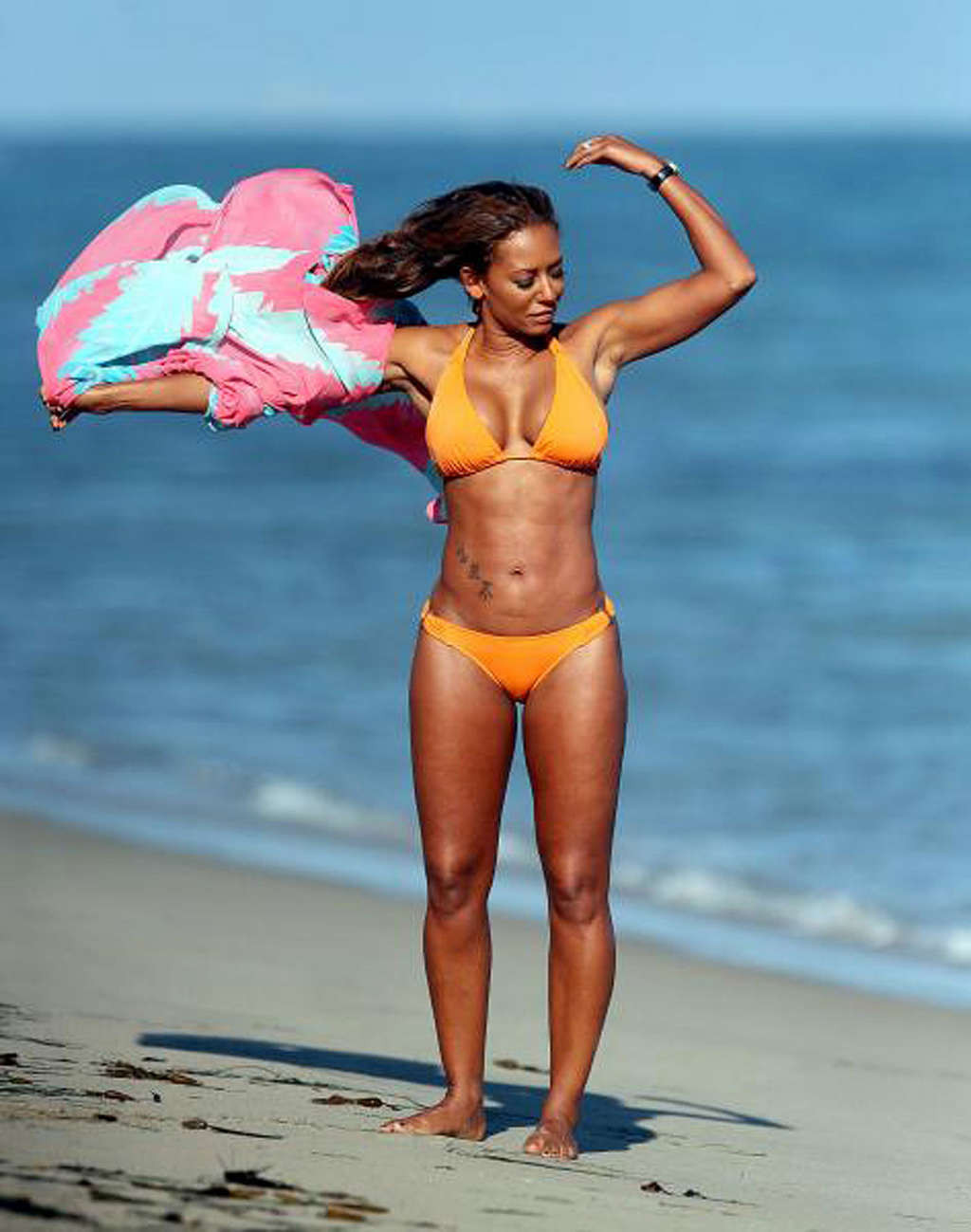 Melanie Brown exposing sexy body and hot ass in yellow bikini on beach #75339635