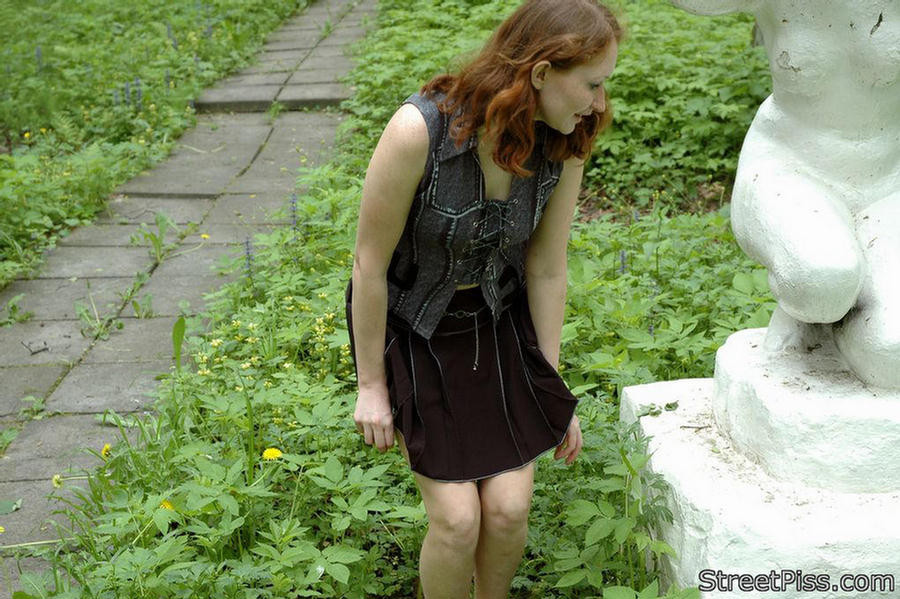 Shy redhead spreads legs to wet a park sculpture #76561825