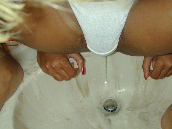 Bizzare girl pissing in the sink #73294401