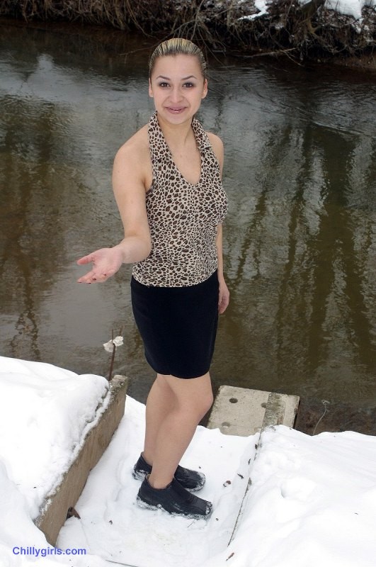 Sexy girl posing and freezing in snow #73285712