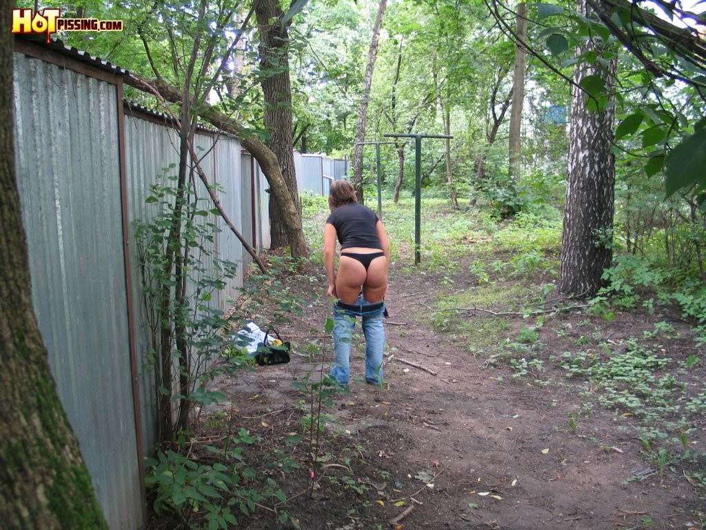 Spy camera shots of a gal in jeans as she does a leak behind a garage #76565067