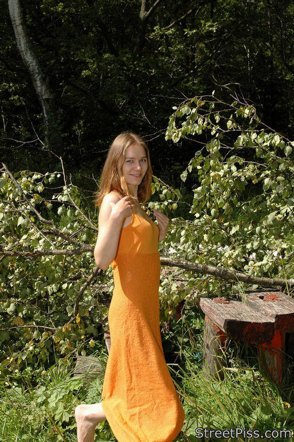 Young hottie in bright dress pees on forest wood #76562544