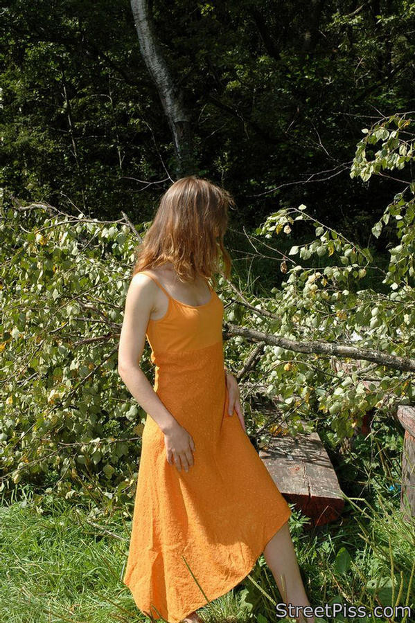 Young hottie in bright dress pees on forest wood #76562552