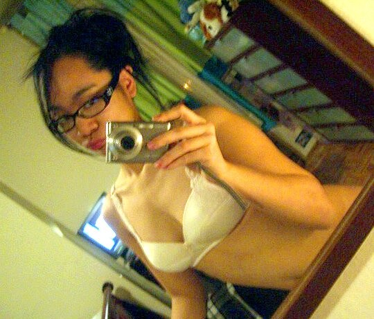 Cute Asian teen with glasses taking selfpics #69962502
