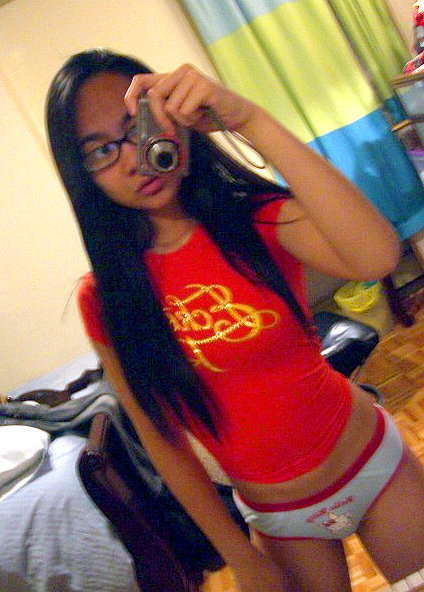 Cute Asian teen with glasses taking selfpics #69962566